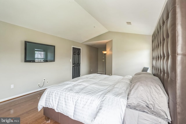 907 Whistling Duck Dr, Upper Marlboro, MD 20774 - bedroom with baseboards, vaulted ceiling, wood finished floors, and visible vents
