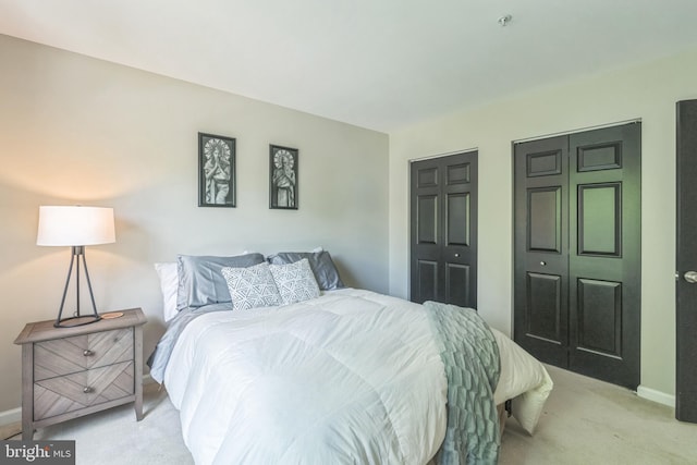 907 Whistling Duck Dr, Upper Marlboro, MD 20774 - bedroom with multiple closets, baseboards, and light colored carpet