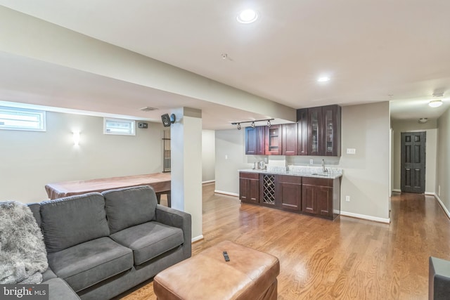 907 Whistling Duck Dr, Upper Marlboro, MD 20774 - living area with indoor wet bar, baseboards, visible vents, and light wood-type flooring