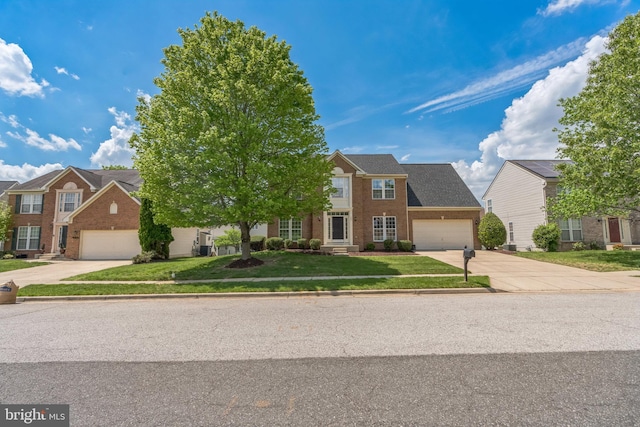907 Whistling Duck Dr, Upper Marlboro, MD 20774 - view of front of house with brick siding, an attached garage, a front yard, and concrete driveway
