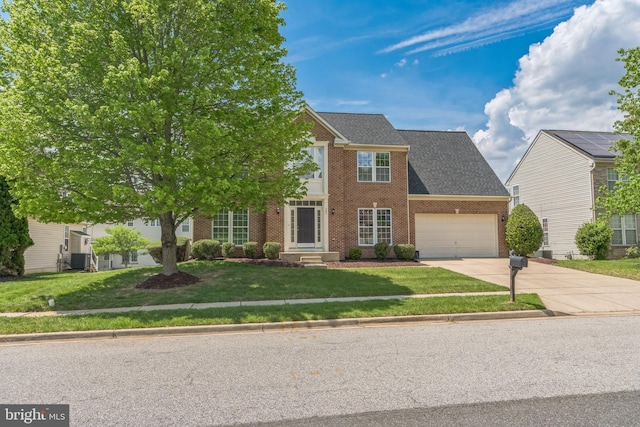907 Whistling Duck Dr, Upper Marlboro, MD 20774 - view of front of house with brick siding, a front lawn, an attached garage, and driveway