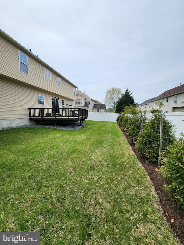 view of yard with fence and a wooden deck