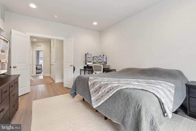 bedroom with recessed lighting, baseboards, visible vents, and light wood-style floors