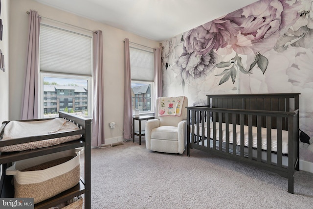 bedroom with carpet and a crib