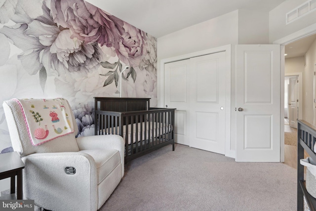 bedroom featuring visible vents, carpet, and a closet