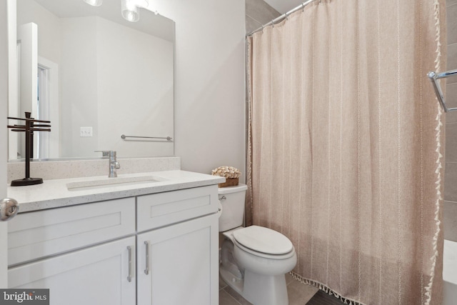 bathroom featuring toilet, curtained shower, tile patterned flooring, and vanity
