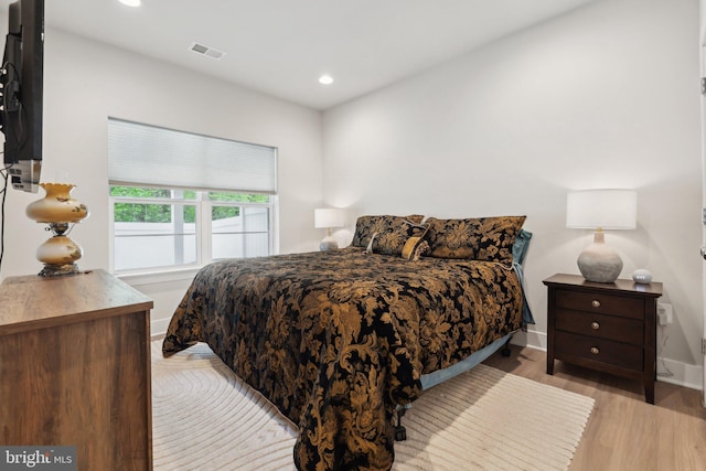 bedroom with recessed lighting, baseboards, light wood finished floors, and visible vents
