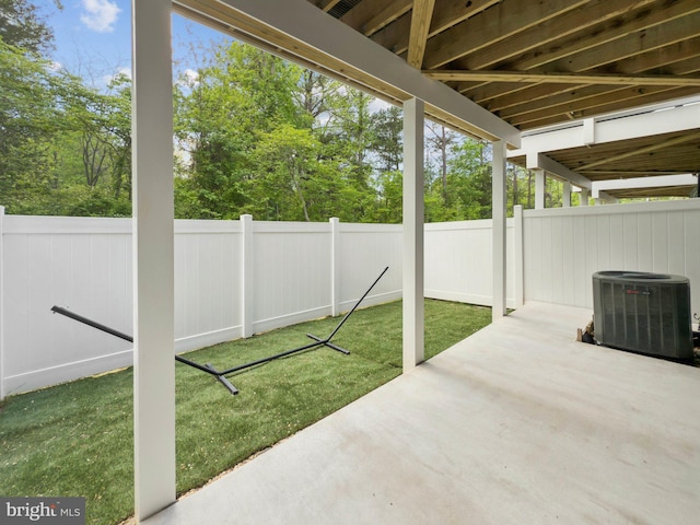view of patio / terrace with cooling unit and a fenced backyard