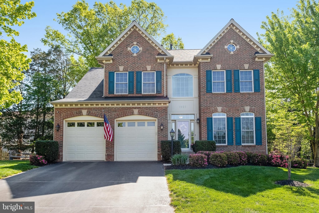 5985 Twin Branch Ct, Haymarket, VA 20169 - view of front facade featuring roof with shingles, a front yard, brick siding, and aphalt driveway