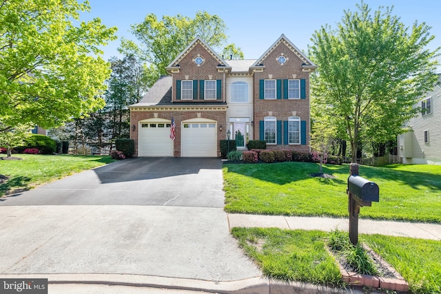 5985 Twin Branch Ct, Haymarket, VA 20169 - view of front facade with brick siding, an attached garage, driveway, and a front yard