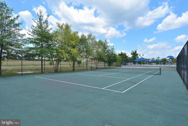 view of tennis court with fence