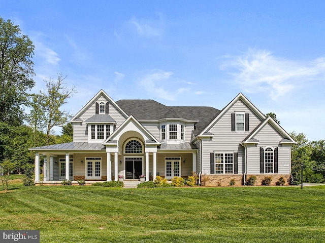 2204 Messina Ct, Eldersburg, MD 21784 - craftsman house with a standing seam roof, french doors, brick siding, and a front lawn