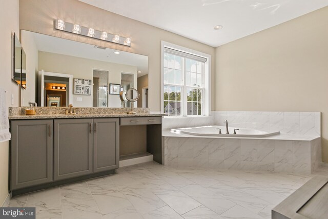2204 Messina Ct, Eldersburg, MD 21784 - bathroom with a garden tub, marble look tile flooring, and vanity