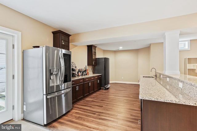 2204 Messina Ct, Eldersburg, MD 21784 - kitchen featuring stainless steel refrigerator with ice dispenser, dark brown cabinets, light wood-style flooring, light stone counters, and recessed lighting