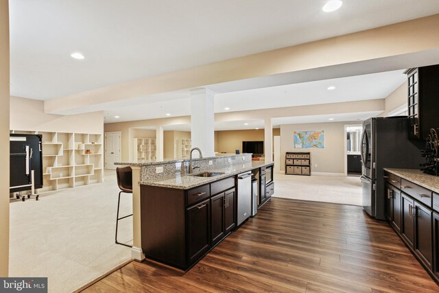 2204 Messina Ct, Eldersburg, MD 21784 - kitchen with a sink, open floor plan, stainless steel appliances, a kitchen bar, and light stone countertops
