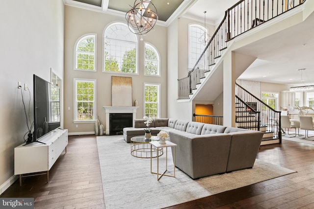 2204 Messina Ct, Eldersburg, MD 21784 - living room with stairs, a chandelier, a high ceiling, healthy amount of natural light, and dark wood finished floors