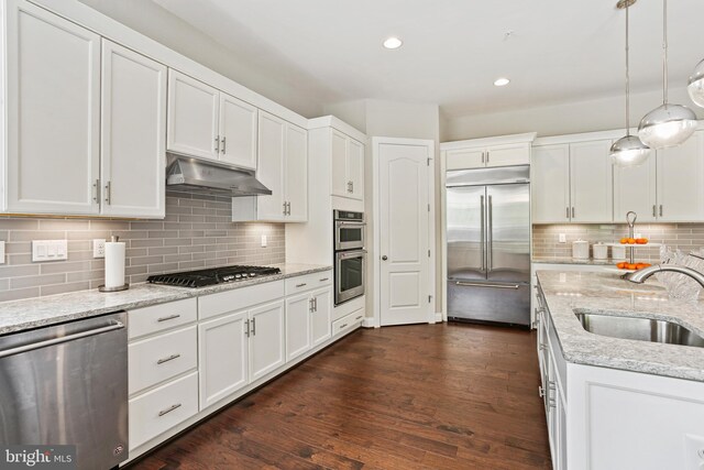 2204 Messina Ct, Eldersburg, MD 21784 - kitchen with stainless steel appliances, a sink, under cabinet range hood, white cabinetry, and tasteful backsplash