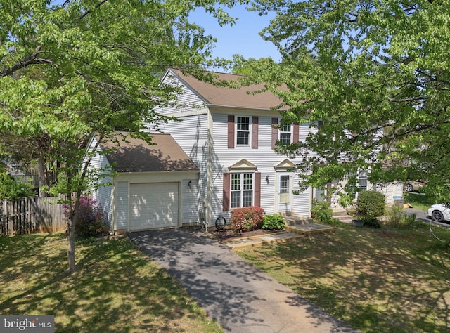 colonial house featuring an attached garage, aphalt driveway, fence, and roof with shingles