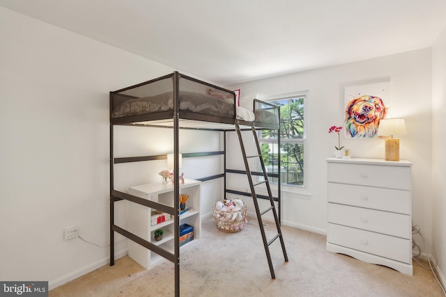 bedroom with baseboards and carpet