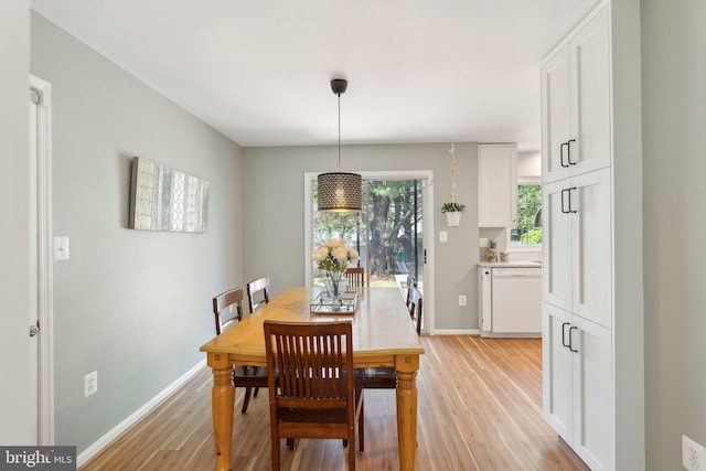 dining room featuring baseboards and light wood-style flooring