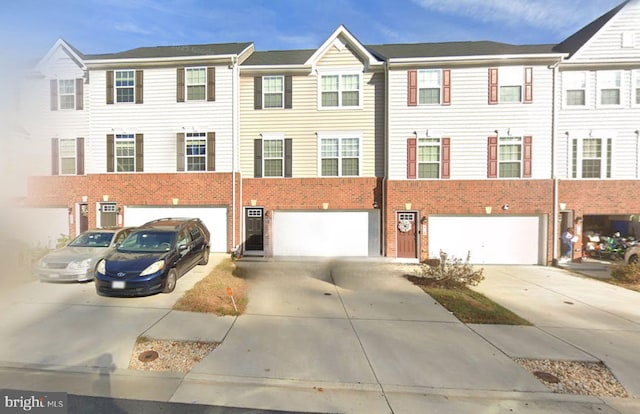 view of front of house with brick siding, driveway, and a garage