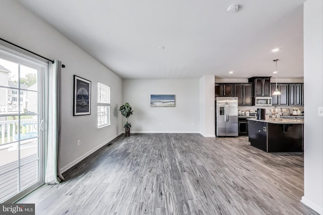 520 View Point Way, Fredericksburg, VA 22405 - kitchen featuring stainless steel appliances, a kitchen bar, plenty of natural light, light wood finished floors, and recessed lighting