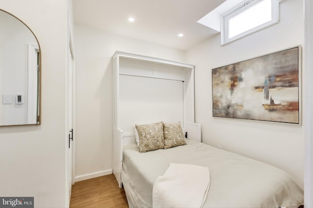 bedroom featuring baseboards, attic access, recessed lighting, and light wood-style flooring