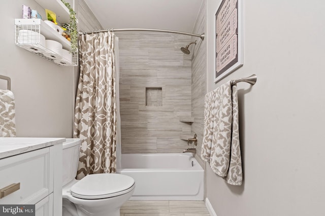 bathroom featuring toilet, baseboards, shower / bath combo, and vanity