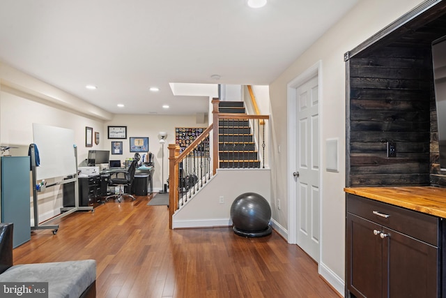 home office featuring baseboards, recessed lighting, and wood finished floors