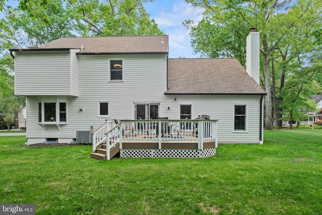 back of house featuring roof with shingles, a deck, central AC unit, a chimney, and a lawn