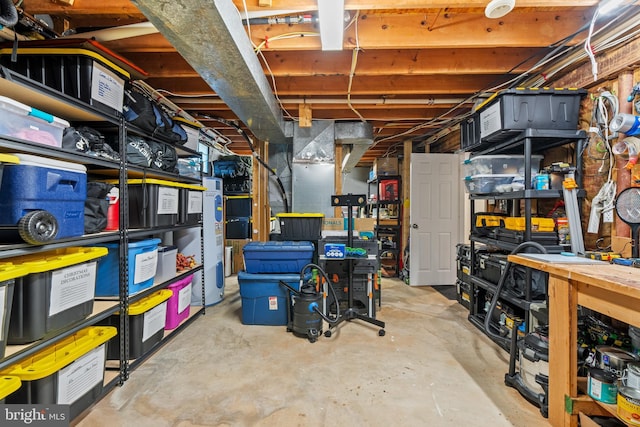 unfinished below grade area featuring water heater