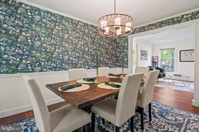 dining space with an inviting chandelier, wainscoting, wallpapered walls, and hardwood / wood-style floors
