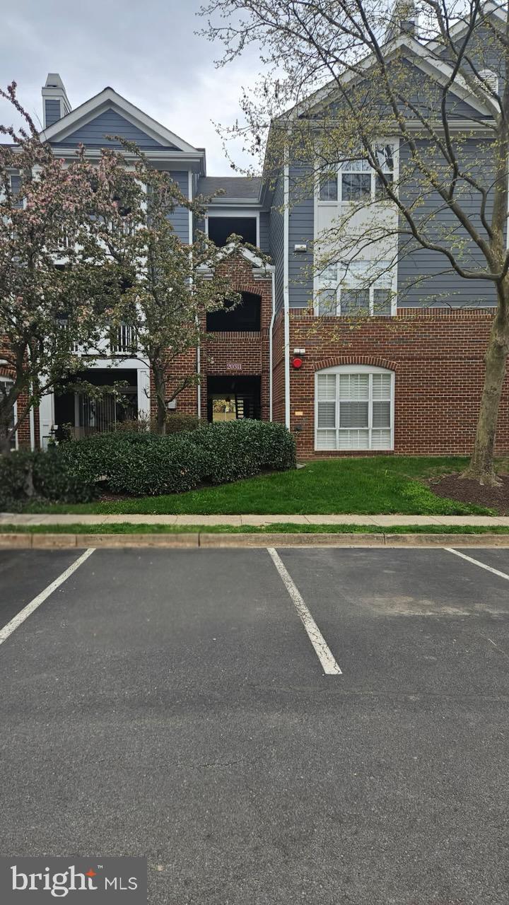 view of property featuring uncovered parking