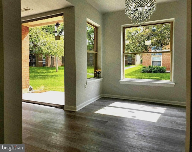 3811 Saint Barnabas Rd Unit T2, Suitland, MD 20746 - unfurnished dining area featuring a chandelier, baseboards, and wood finished floors