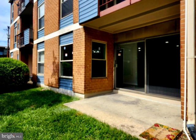3811 Saint Barnabas Rd Unit T2, Suitland, MD 20746 - entrance to property featuring brick siding, a patio, and a yard