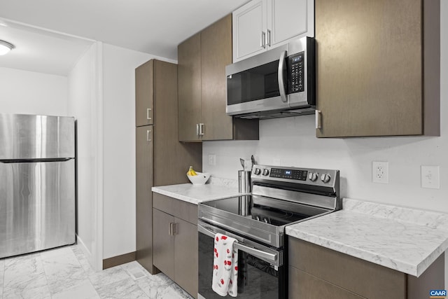 28 Begum Rd, Palmyra, VA 22963 - kitchen with baseboards, marble finish floor, light countertops, and appliances with stainless steel finishes