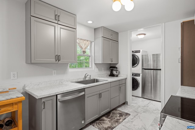 28 Begum Rd, Palmyra, VA 22963 - kitchen featuring stacked washer / dryer, a sink, gray cabinets, appliances with stainless steel finishes, and marble finish floor