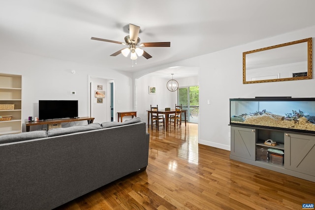 28 Begum Rd, Palmyra, VA 22963 - living area featuring baseboards, wood finished floors, ceiling fan with notable chandelier, and arched walkways