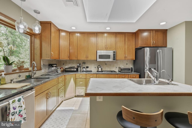 3305 Shirley Ln, Chevy Chase, MD 20815 - kitchen featuring appliances with stainless steel finishes, a sink, a kitchen bar, tasteful backsplash, and recessed lighting