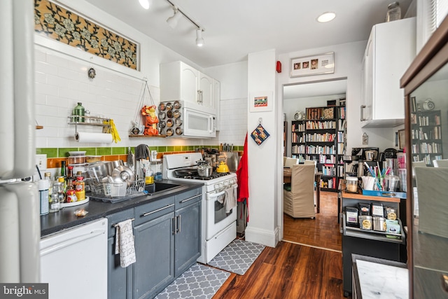 5217 Greene St, Philadelphia, PA 19144 - kitchen with dark countertops, white appliances, rail lighting, white cabinetry, and dark wood-type flooring