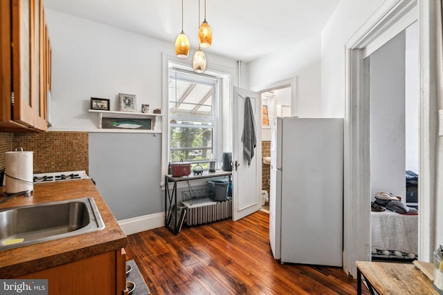 5217 Greene St, Philadelphia, PA 19144 - kitchen featuring a sink, freestanding refrigerator, decorative light fixtures, tasteful backsplash, and dark wood-type flooring