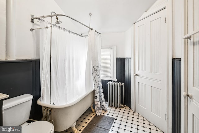 5217 Greene St, Philadelphia, PA 19144 - bathroom with radiator, tile patterned floors, vaulted ceiling, and toilet