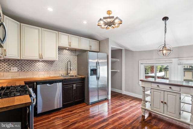 5217 Greene St, Philadelphia, PA 19144 - kitchen with decorative backsplash, a sink, dark wood-style floors, stainless steel appliances, and butcher block countertops
