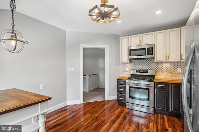 5217 Greene St, Philadelphia, PA 19144 - kitchen featuring appliances with stainless steel finishes, a chandelier, baseboards, tasteful backsplash, and dark wood-type flooring