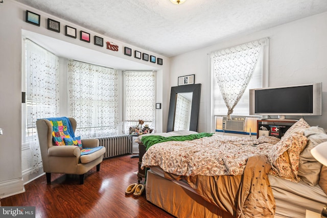 5217 Greene St, Philadelphia, PA 19144 - bedroom featuring a textured ceiling, radiator, wood finished floors, and multiple windows