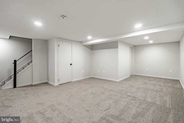 finished basement featuring recessed lighting, baseboards, carpet, and stairs