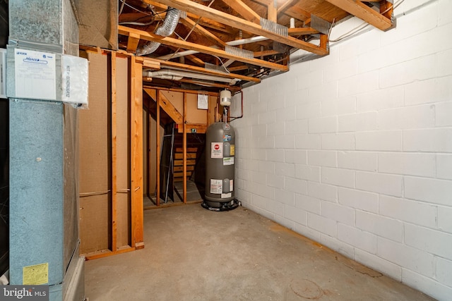 unfinished below grade area with concrete block wall and electric water heater