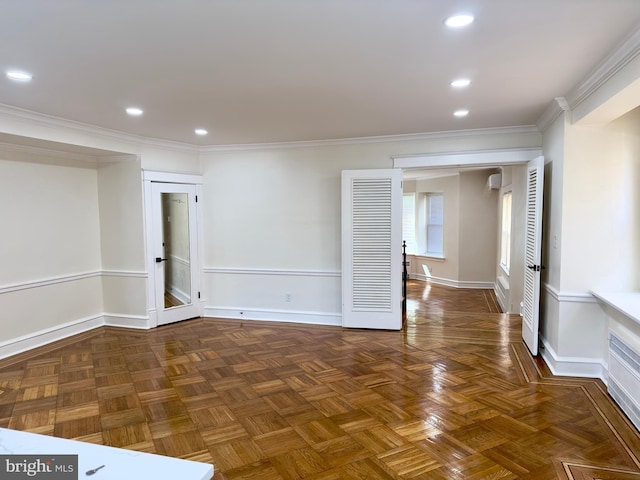 spare room featuring crown molding, recessed lighting, and baseboards