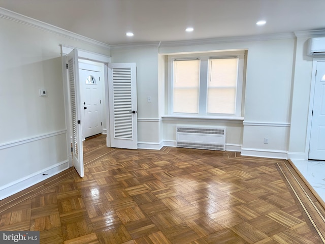 interior space with ornamental molding, baseboards, radiator heating unit, recessed lighting, and a wall unit AC