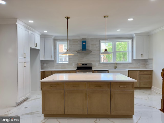 kitchen with crown molding, marble finish floor, wall chimney exhaust hood, a sink, and appliances with stainless steel finishes